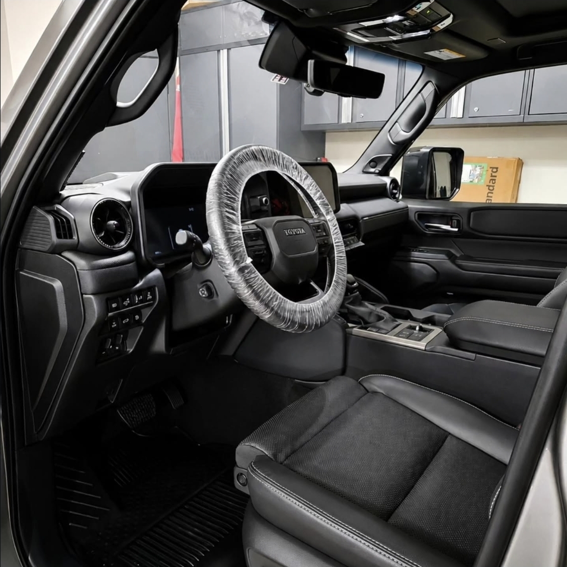 Toyota SUV interior with protective steering wheel cover after detailing